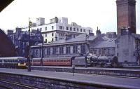 Black Five number 45489 propels empty stock into St Enoch station. The background consists of the Lewis department store and a vent for the Central low level line.<br><br>[G W Robin 07/07/1965]