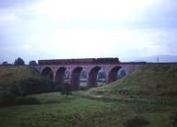A Black 5 takes a train over Long Marton viaduct on the Settle and Carlisle Line just north of Appleby in the 1960s.<br><br>[Robin Barbour Collection (Courtesy Bruce McCartney) //]