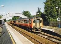 A 4-car 156 set for Glasgow Queen Street at Lenzie in July 1999.<br><br>[David Panton /07/1999]