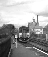 156436 departs from Driffield on 29 March 2006 heading for Bridlington. The interesting looking building in the background is a former sugar-beet processing mill.<br><br>[Peter Todd 29/03/2006]