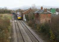 A Class 60 heads south with a freight past the former Woofferton station, Shropshire, on 18 November 2008. The station, closed in July 1961, still retains its signalbox, passing loop and fine array of ex-GW signals together with a former goods shed (although it has seen better days). Just beyond the signal box was the junction for the branch line to Tenbury Wells where the S&HJ stopped but the GW continued through Cleobury Mortimer to Bewdley. The Clee hills form the backdrop.<br>
<br><br>[John McIntyre 18/11/2008]