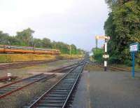 Looking east from the end of the platform at Killarney station in 1991. Running along the embankment on the left towards the junction is a train on the Tralee - Dublin Heuston main line.<br><br>[Bill Roberton //1991]