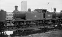 Reid N15 0-6-2T no 69143 stands in a siding at Thornton in July 1958. In the background is one of the towers of Rothes Colliery, opened by HM The Queen that year and hailed as one of the new generation of <I>Superpits</I> with a projected lifespan of 100 years. The decision was taken to abandon the site 4 years later due to flooding and geological problems.<br><br>[Robin Barbour Collection (Courtesy Bruce McCartney) 29/07/1958]