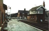 A morning view towards Skegness, at Wainfleet on Easter Saturday 1994, showing the surviving semaphores, crossing gates and GNR signal box. The Skegness branch has undergone considerable investment recently with a view to improving timings. For a number of years long stretches beyond Boston were subject to 30mph speed restrictions because of the poor state of the track. <br><br>[Mark Bartlett 02/04/1994]