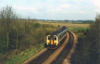 The famous Firsby Curve, built by the GNR in 1881, linked the East Lincolnshire Railway to the Wainfleet and Firsby and allowed through running of trains from the East Midlands to Skegness. The other East Lincolnshire lines, and Firsby station, closed in 1970 and have been swept away in the flat farming landscape leaving just the long branch from Boston to Skegness with that sharp curve that is such a feature of railway maps. 156402 slowly negotiates the curve as it heads for Boston and beyond. <br><br>[Mark Bartlett 09/04/1994]