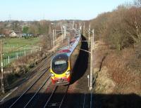 The footbridge at Broad Fall Farm near Scorton is exactly 12 miles north of Preston, and just south of the site of the former station, which closed in 1939. Here, a Pendolino leans on the curve as it heads south. Map Ref SD 503478.<br><br>[Mark Bartlett 06/12/2008]