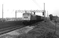 North British Class 84 AC Electric 84003 heads south from Preston on the Up Fast line with a parcels service. The train has just passed over the former West Lancashire line to Southport and is now climbing towards Farington Curve Junction. There were only ten of these AL4 locos and by 1980 they were <I>rare birds</I> so I was pleased to capture this one, which was one of the last three survivors but withdrawn by November. I first saw them in the early 1970s when, along with the EE Class 83s, they were stored in the former steam shed at Bury for several years.<br><br>[Mark Bartlett 16/06/1980]