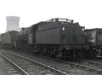 Stanier 2-6-0 no 42963, with coupling rods etc removed, stands in the sidings at the south end of 56A Wakefield shed in the latter part of 1966 on its way from Springs Branch, Wigan, to Drapers scrapyard, Hull, where it was cut up in January of 1967. Both the shed and the power station in the background have since been demolished. [With thanks to David Pesterfield.]<br>
<br><br>[Robin Barbour Collection (Courtesy Bruce McCartney) //1966]