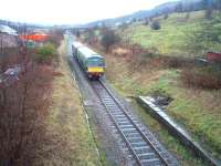 Another <I>Then and Now</I> comparison with a Cam Camwell pre closure picture [See image 21224] on the East Lancashire Railway at the site of Ewood Bridge and Edenfield. Although the station has not reopened under preservation the site has been greatly improved and the <I>waterfall</I> on the platform has been diverted into a substantial drain just in front of the train. The Met Cam DMU is heading for Ramsbottom with the first shuttle of the day and will connect with a Santa Special for Bury. <br><br>[Mark Bartlett 13/12/2008]