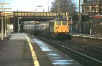 87015 <I>Howard of Effingham</I> heads for Euston on the Up Fast  through Leyland in 1980. Apart from the stock used on the express trains Leyland station has changed little in the years since this picture was taken. Although many of the Class 87s are now embarking on a new lease of life in Bulgaria 87015 was withdrawn in November 2004 and cut up the following October at MoD Caerwent.<br><br>[Mark Bartlett 22/12/1980]