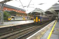 153332 leads a Class 156 unit out of Preston with a service to Carlisle on 15 October 2008, while over on the left 92039 <I>Johann Strauss</I> waits for a path north with a tank train. Both are heading for Carlisle and although the passenger has set off first the freight will arrive before it, given it will take the direct route over Shap, with the DMU travelling via Barrow in Furness and the Cumbrian Coast.<br>
<br><br>[John McIntyre 15/10/2008]