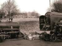 73096 and 92212 resting at Ropley shed on the Mid Hants Railway, after their Christmas exertions. I was told by an elderly, bearded gentleman that the pallet-like attachment on the chimney of the 9F was part of an experiment being undertaken on behalf of the Health and Safety Executive aimed at the prevention of erroneous incursions by Santa at this time of year.<br><br>[Peter Todd 28/12/2006]