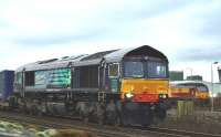 DRS 66433 departs Inverness with containers for Grangemouth on Chrismas Eve 2008 passing 67011 standing in the background.<br><br>[John Gray 24/12/2008]