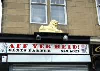 The office/shop once used by coal merchant John Lyon in Glasgow Road, Paisley, (just round the corner from the former Paisley East yard)photographedin December 2008 complete withclassical Lion <I>couchant</I> (one of a pair) still in place above the shop front.Thesecond member of the pair [see image 21161], stood in the John Lyon coal yardalongside Hawkhead station, some44 years earlier.<br>
<br><br>[Colin Miller 25/12/2008]