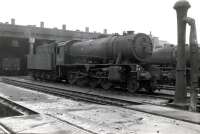 WD Austerity 2-8-0 no 90645, one of 733 such freight locomotives taken over by BR from the Ministry of Supply in 1948, stands outside the former L&Y eight road straight shed that was 56A, Wakefield, in 1966. The locomotive was withdrawn in January 1967, the same month that saw official closure of 56A. No 90645 was cut up at Wards, Killamarsh, 3 months later while the former Wakefield shed was put to use as a wagon repair depot until the late 1980s following which it was eventually demolished. [With thanks to David Pesterfield.]   <br>
<br>
<br><br>[Robin Barbour Collection (Courtesy Bruce McCartney) //1966]