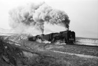 A pair of QJ 2-10-2 locomotives hauling a heavy freight over Shangdian Summit in the Jing Peng pass, part of the Ji-Tong Railway in North East China. Photographed on 20 February 2002.  <br>
<br><br>[Peter Todd 20/02/2002]