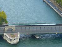 A Paris Metro Line 6 train crosses the Seine on Pont Bir-Hakeim between Passy and Bir-Hakeim stations on 1 October 2008. The railway viaduct here is supported by metal colonnades above the road surface of the bridge, except where it passes over the le des Cygnes, where it rests on the masonry arch seen on the left.<br>
<br><br>[Fraser Cochrane 01/10/2008]