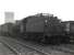 Stanier 2-6-0 no 42963, with coupling rods etc removed, stands in the sidings at the south end of 56A Wakefield shed in the latter part of 1966 on its way from Springs Branch, Wigan, to Drapers scrapyard, Hull, where it was cut up in January of 1967. Both the shed and the power station in the background have since been demolished. [With thanks to David Pesterfield.]<br>
<br><br>[Robin Barbour Collection (Courtesy Bruce McCartney) //1966]