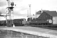 Guild Street yard, Aberdeen in the early 1970s. BR class 08 no D3877 undertakes the shunting duties as class 47 no 1708 prepares to move a southbound freight out of the yard.<br>
<br><br>[John McIntyre 07/02/1973]