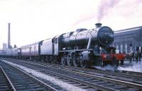 Stanier 8F 2-8-0 no 48773 with the MRTS/SVRS North West Tour from Birmingham New Street on 20 April 1968, during its scheduled 10 minute photostop at Broadfield. The station buildings and platform canopy can be seen above the rear coaches (station closed to passengers in October 1970) and the chimney of Heywood's Unity Mill  dominates the background.   <br><br>[Robin Barbour Collection (Courtesy Bruce McCartney) 20/04/1968]