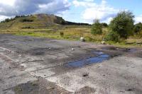 A short surviving section of the former 2ft 8in gauge surface railway at Comrie Colliery, Fife, seen in September 2008. An old coal bing stands in the background.  <br><br>[Bill Roberton 04/09/2008]