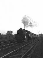 Standard class 5 no 73072 of Polmadie shed drifts through Hillington West towards Glassgow in the sunset with an up freight in May 1963.<br>
<br><br>[Colin Miller 11/05/1963]
