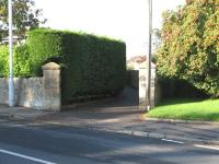 Looking west over the former level crossing on the Netherton Branch of the Elgin Railway in Limekilns Road, Dunfermline.  The footpath roughly follows the route of the Branch.  The Netherton Terminus was Dunfermline's first passenger station, opening in 1834 (the earliest rail passenger service in Fife) and provided a service to Charlestown until 1863. Freight on the Netherton branch lasted until 1964.<br><br>[Mark Poustie 23/09/2006]