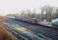 With around 80 trains in each direction every day (Monday  to Saturday) there is always something happening at Kirkham and Wesham. The four tracks that run from east of the station to beyond Kirkham North Junction also give a very flexible operating layout. In this view, towards Salwick from the overbridge, 156441 on the Up Slow calls at the station with the fast lines visible in the foreground.<br><br>[Mark Bartlett 06/01/2009]