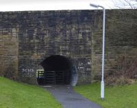 Old bridge on the B920, Main Street, Lochore, over the trackbed of the Thornton-Westfield-Kelty branch. Only the western parapet of the bridge remains, the other side having been landscaped. It would appear that reclaimed stone has been used to infill the span at some stage.<br><br>[Bill Roberton 15/01/2009]