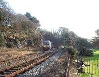 A train for Barrow in Furness from Manchester Airport, formed by 185147, passes the site of Furness Abbey station, closed in 1950, and enters the short tunnel. Furness Abbey itself, a red sandstone ancient monument, sits alongside the line here in a secluded valley and the grounds can just be seen to the right of the train.  <br><br>[Mark Bartlett 17/01/2009]