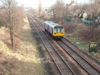 The Heysham boat train now only makes one daily return trip on the branch to the port since the December 2008 timetable change. However, the train does now run through to and from Leeds via Hellifield rather than just shuttling to Lancaster. 142054, newly repainted from Merseyrail yellow, approaches York Bridge on its way to Morecambe (reverse) and Heysham Port in this view east towards Bare Lane.<br><br>[Mark Bartlett 21/01/2009]