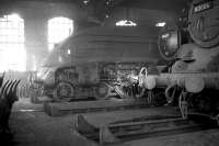 Twilight of steam at Dalry Road shed in January 1964. Residents include A4 Pacific 60006 <I>Sir Ralph Wedgwood</I>, stored here temporarily between transfer from Peterborough's New England shed in late 1963 and reinstatement at Ferryhill on 4 May 1964. Also present are Black 5 45477 and standard class 4 tank 80006. Dalry Road shed was officially closed on 3 October 1965.<br><br>[Robin Barbour Collection (Courtesy Bruce McCartney) 03/01/1964]