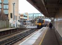 The level crossing at Feltham station has a mournful clanging gong that reminded me more of SW Europe than SW London.  The railwayman, striding purposefully down the platform as SWT 450545 approaches, was just going about his business and unconcerned about photography, unlike the Editor's experience at Airdrie around the same time [see image 21892].<br><br>[Mark Bartlett 16/01/2009]