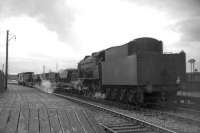 Ex-WD Austerity 2-8-0 no 90463 leaves the Kilmarnock platform at Barassie with a short ballast train in the summer of 1963.<br>
<br><br>[Colin Miller /07/1963]