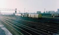 View west towards King Edward Bridge East Junction from Gateshead MPD on a summer evening in 1982 with the Gateshead breakdown crane standing on the <I>ash heaps</I> at the west end of the depot. The line to the right at the junction runs onto the bridge, part of which can be seen between the breakdown train and the class 31. The line to the left joins the ECML from Newcastle Central shortly after it leaves the bridge. <br>
<br><br>[Colin Alexander //1982]