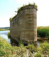 Like the marooned hulk of some ancient battleship, the massive stone pier that once supported the railway bridge carrying the Jedburgh branch over the Teviot still stands defiant alongside the south bank of the river near the remains of Jedfoot station. View northeast along the River Teviot as it winds downstream to join forces with the Tweed at Kelso. <br>
<br><br>[John Furnevel 01/07/2008]