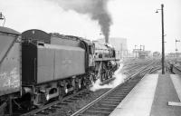 BR Standard Class 6 Pacific no 72006 'Clan MacKenzie', photographed prior to restarting a southbound freight following a signal check at Stirling in April 1965. 72006 survived another year, being finally withdrawn from Carlisle Kingmoor shed in May of 1966. Two months later Clan MacKenzie succumbed to the blowtorches of the Clan McWilliams of Shettleston.   <br><br>[Robin Barbour Collection (Courtesy Bruce McCartney) 16/04/1965]