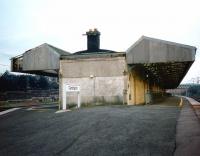 The doomed, crumbling building at Carstairs with its odd gull-wing canopies, seen looking along the WCML towards Glasgow on 29 Aug 1997.<br><br>[David Panton 29/08/1997]