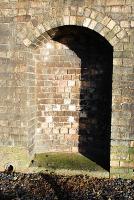 In times gone by primitive railwaymen placed votive statues in this alcove ... perhaps not. There are a number of safe recesses along the massive retaining wall between the former Galashiels station and Ladhope Tunnel. At 1600 on the 14th of December 1916 there was an enormous landslip here when 70 yards of cutting collapsed blocking the mainline for many days. Before the fall the original retaining wall was buttressed, then reinforced with rails, before the gaps between buttresses were bricked up. But cracks kept reappearing and repairs were in hand when the landslip took place, the workmen barely having time to escape. The impressive rebuilt walls remain intact today.<br><br>[Ewan Crawford 17/01/2009]