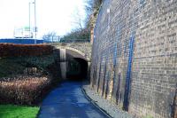 Ladhope Tunnel looking north. The view looks towards Edinburgh at the spot  the 1916 landslip occurred. The retaining wall to the right has a second of similar height above it. Alterations in favour of the road here have left the tunnel with an unaltered double track entry at the north end and sort of single track exit at the south end.<br><br>[Ewan Crawford 17/01/2009]