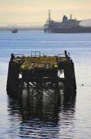 Britain's shortest railway? The remains of an old Admiralty jetty standing in the Firth of Forth just off Carlingnose Point, to the east of North Queensferry station in February 2009. The surviving rails of the 3 ft gauge double track railway can be clearly seen on the decking. In the middle distance a tanker is loading North Sea oil at the BP terminal off Hound Point on the south shore, while in the left background lies the City of Edinburgh, with the framework of the old Granton gasometer to the fore.  <br>
<br><br>[Bill Roberton 06/02/2009]