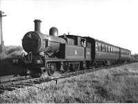 Another last weekend of services picture on the Holcombe Brook branch of the Bury and Tottington District Railway, but unfortunately it is also the last submission in this small collection of pictures. A smart looking Bury crew pose for Cam Camwell from the footplate of L&YR Radial 2-4-2T 50655 as they run into the Holcombe Brook terminus after another 3 mile run from Bury Bolton St, calling at six intermediate halts and stations on the way. The official closure date was Monday 5 May 1952.<br>
<br><br>[W A Camwell Collection (Courtesy Mark Bartlett) 03/05/1952]