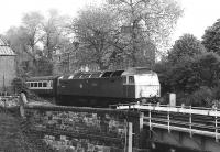 Having turned south west onto the Carstairs line at Haymarket East Junction, 47706 <I>Strathclyde</I> is about to cross the bridge over the <I>sub</I> at the east end of Slateford Yard on 20 May 1981 with the 1305 Edinburgh - Bristol. The tenements of Shandon Crescent stand in the background.<br><br>[Peter Todd 20/05/1981]