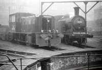 Scene on the up side of St Margarets shed, looking south across the ECML towards London Road on a Saturday morning in September 1958. Standing around the turntable is a North British 0-4-0 DH shunter, no D2723 of 1957, alongside a Reid ex-NBR N15 0-6-2T no 69152 of 1910. Even on a fine day it is questionable how much of a view was ever enjoyed by the nearby residents of London Road at that time, given the 200+ steam locomotives to whom St Margarets was home during much of the 1950s. <br>
<br><br>[Robin Barbour Collection (Courtesy Bruce McCartney) 06/09/1958]