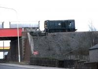 A class 08 working on the Mossend - Ravenscraig no 3 line crossing the bridge over Merry Street, Motherwell, in the 1980s. This bridge was removed in 2008 and transported by rail to the Strathspey Railway, (see old news item) where it will carry the planned extension of the line to Grantown-on-Spey over the River Dulnain. <br>
<br><br>[Johnny Trippick //]