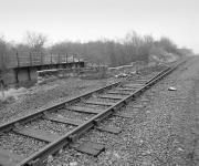 Looking east towards Dunfermline over the Station Road bridge at Oakley in 1987. This survives as part of the cycle route, but the steel bridge beyond has gone.<br>
<br><br>[Bill Roberton //1987]