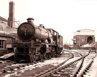 Ex-GWR locomotive 5051 undergoing a valve and piston examination at the Great Western Society depot at Didcot in a snowy February day in 1985.<br><br>[Peter Todd 17/02/1985]