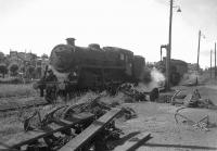 <I>Anchors Aweigh!</I> Locomotives standing alongside the watercrane and anchor depository in the sidings east of Gourock station in 1963, prior to taking out return services to Glasgow.<br>
<br><br>[Colin Miller 12/07/1965]