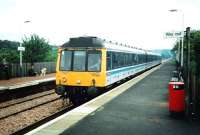 Two men and a dog look on as 117 301 prepares to leave Rosyth with a Cowdenbeath service in June 1997.<br><br>[David Panton /06/1997]