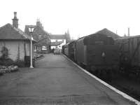 Looking towards the buffer stops at Kirkcudbright on 14 September 1963. A Royal Mail van stands on the platform and Black 5 no 45480 prepares to take out the 4.51pm train to Dumfries, having completed some shunting in the yard.<br><br>[Robin Barbour Collection (Courtesy Bruce McCartney) 14/09/1963]